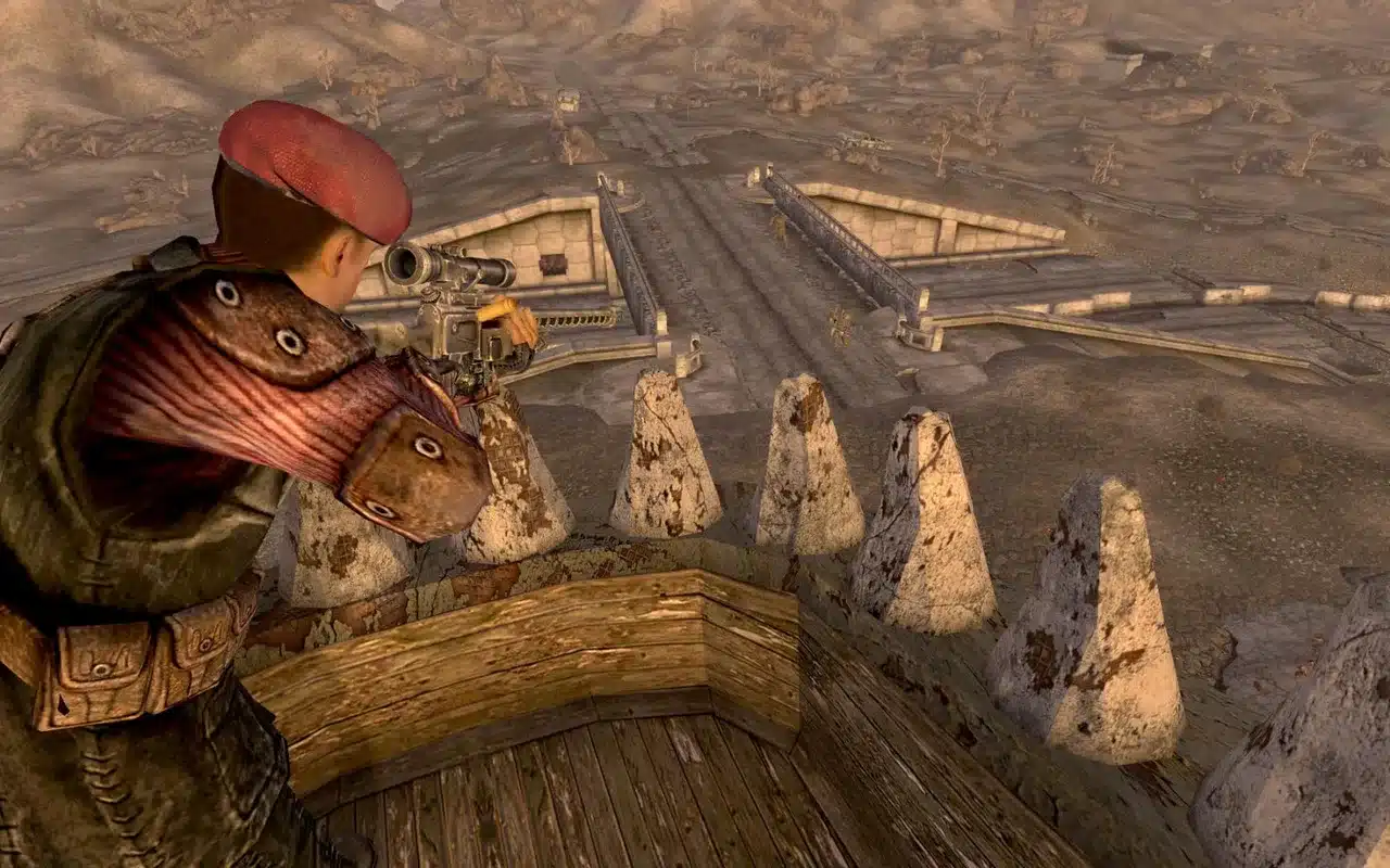 Fallout: New Vegas: снайпер Крейг Бун в красном берете целится с крыши мотеля в Новаке, внизу ряды бетонных надолбов